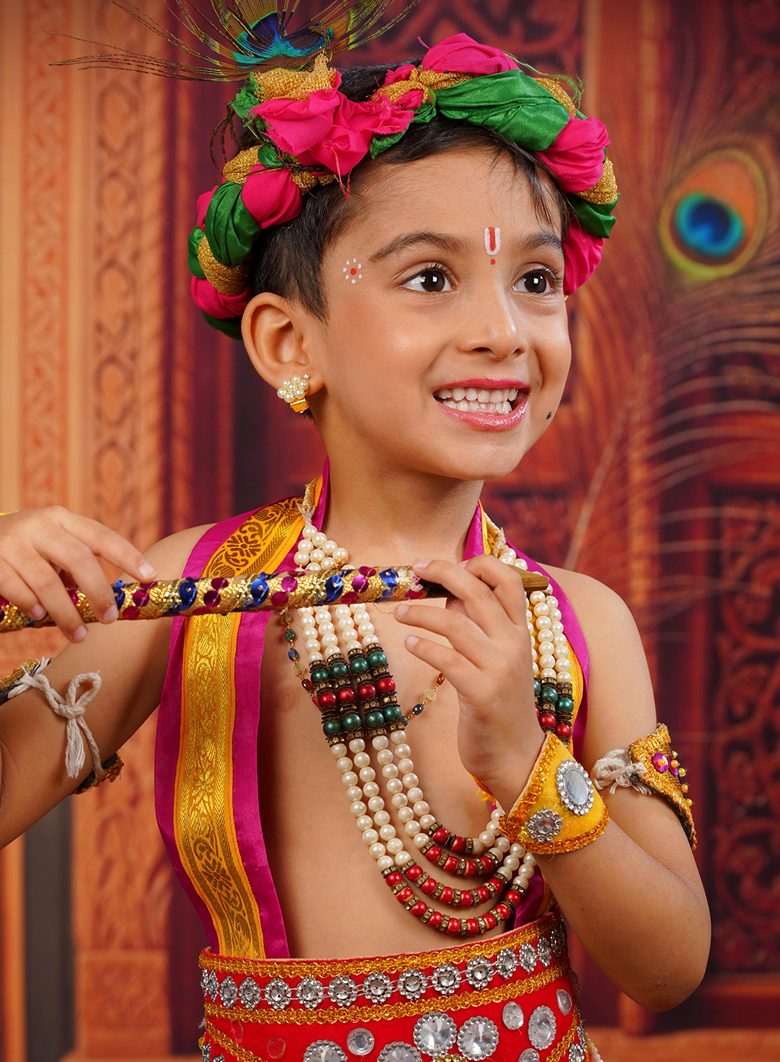 A child dressed as little Krishna with a peacock feather
