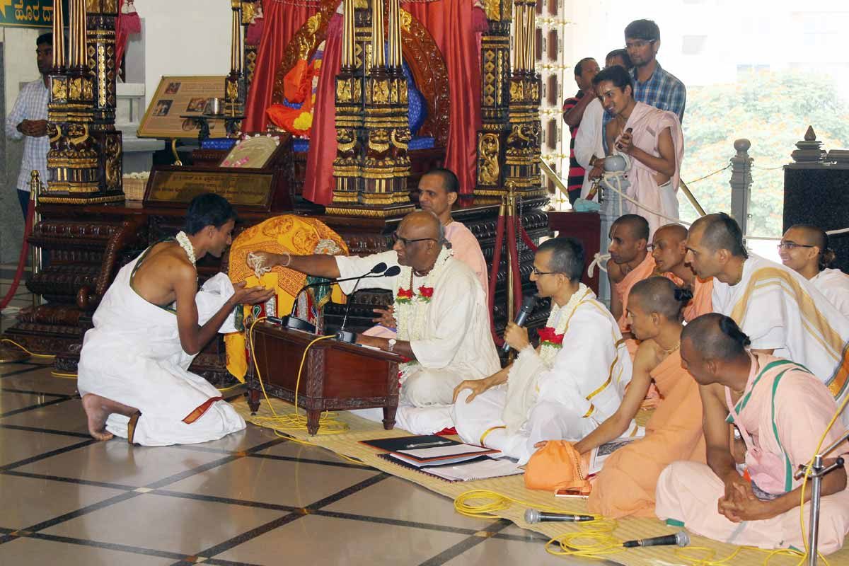 Temple President offering Diksha to a Devotee